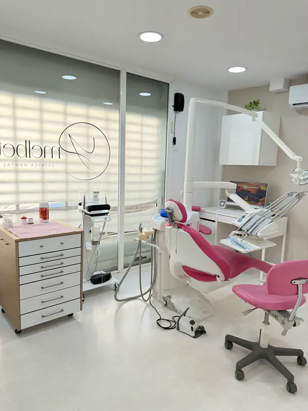Gabinete dental con sillón rosa y luz natural